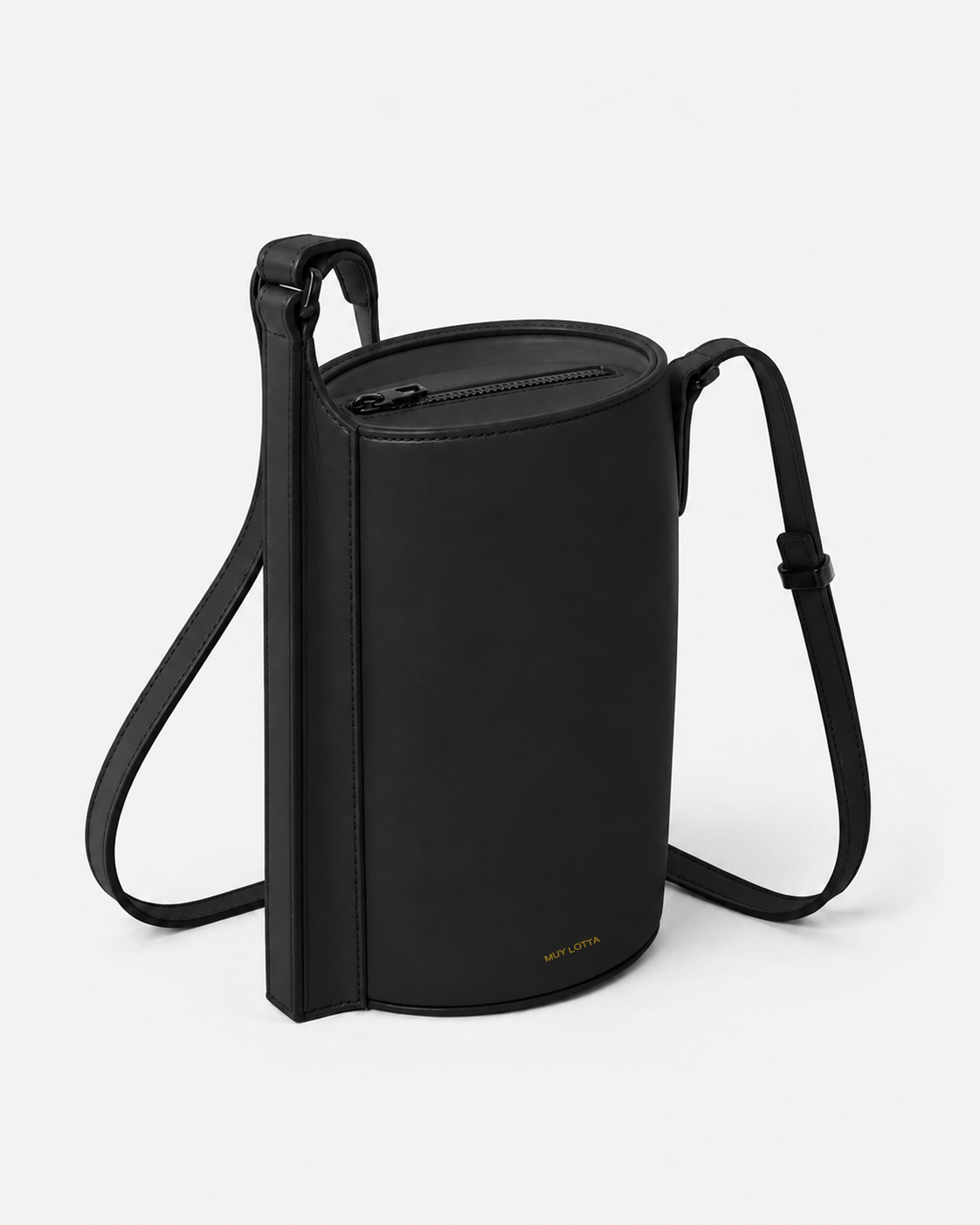 MUYLOTTA ML-CB05 black cylinder crossbody bag, three-quarter view, with an oval cylinder and continuous side spine.