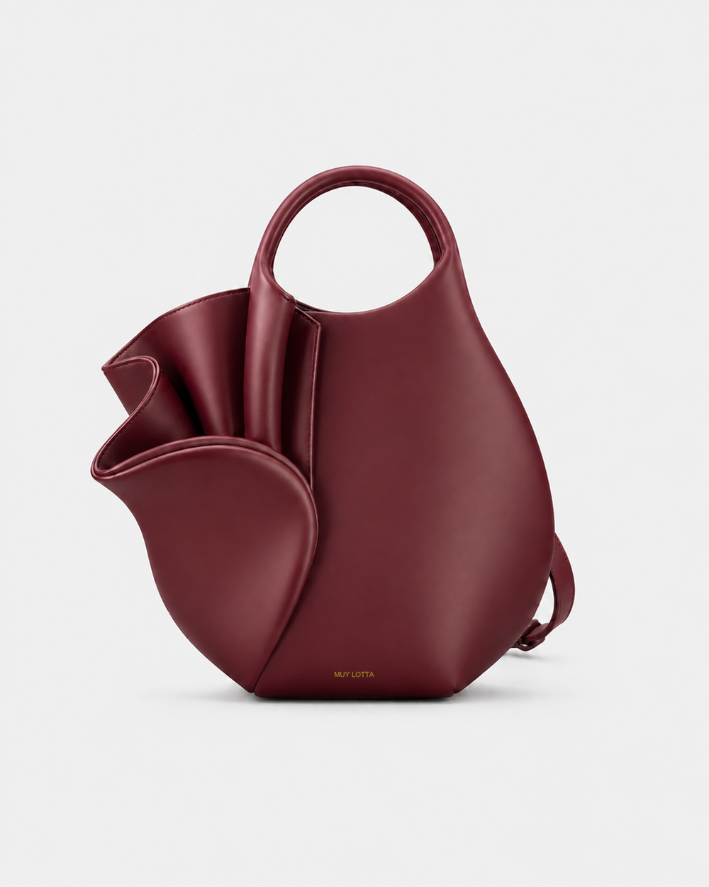 MUYLOTTA ML-MN05 burgundy sculptural mini bag, three-quarter view, with a ring handle and one outward-folded side panel.