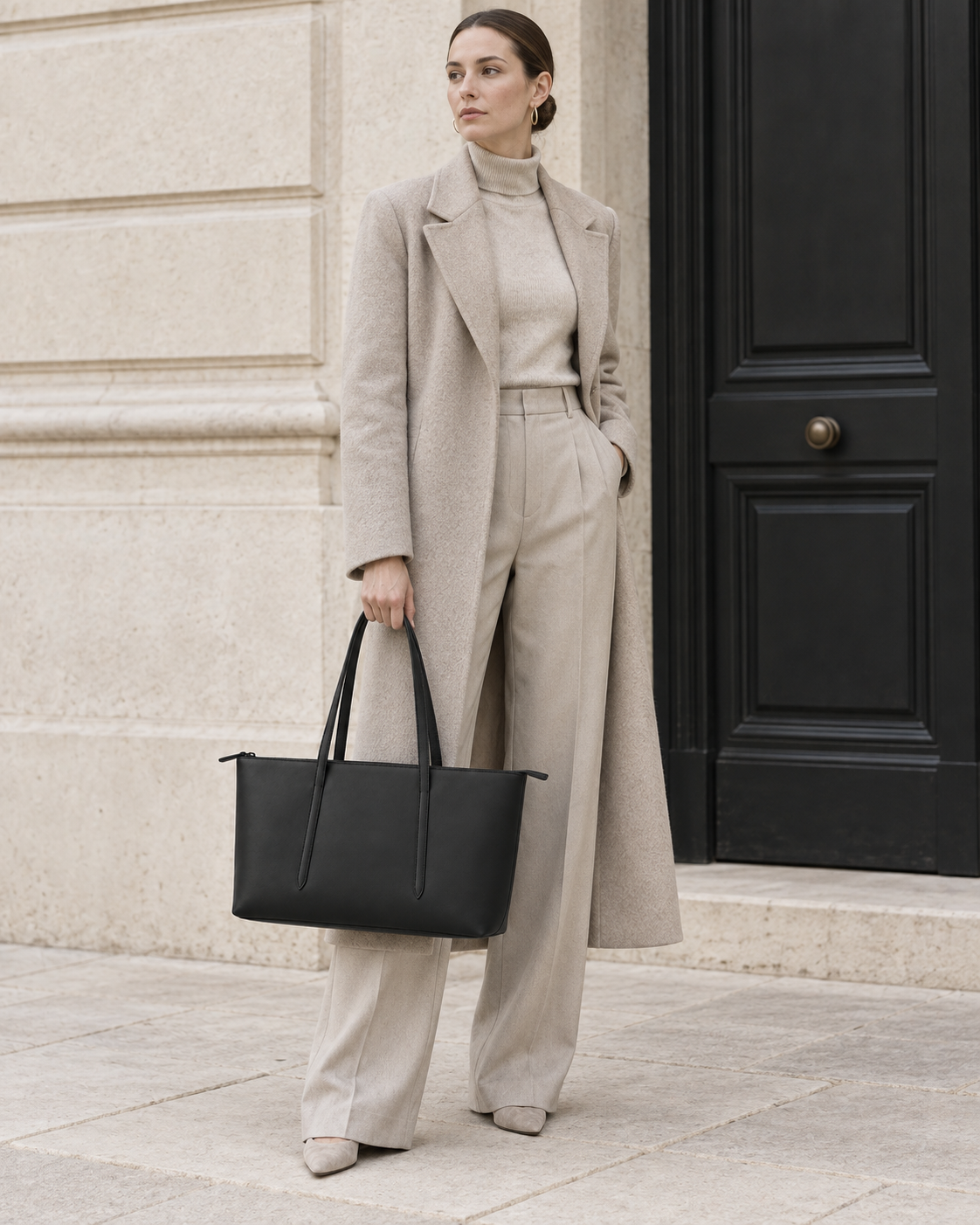 Woman carries the black MUYLOTTA ML-TT02 east-west tote in a second shoulder styling view.