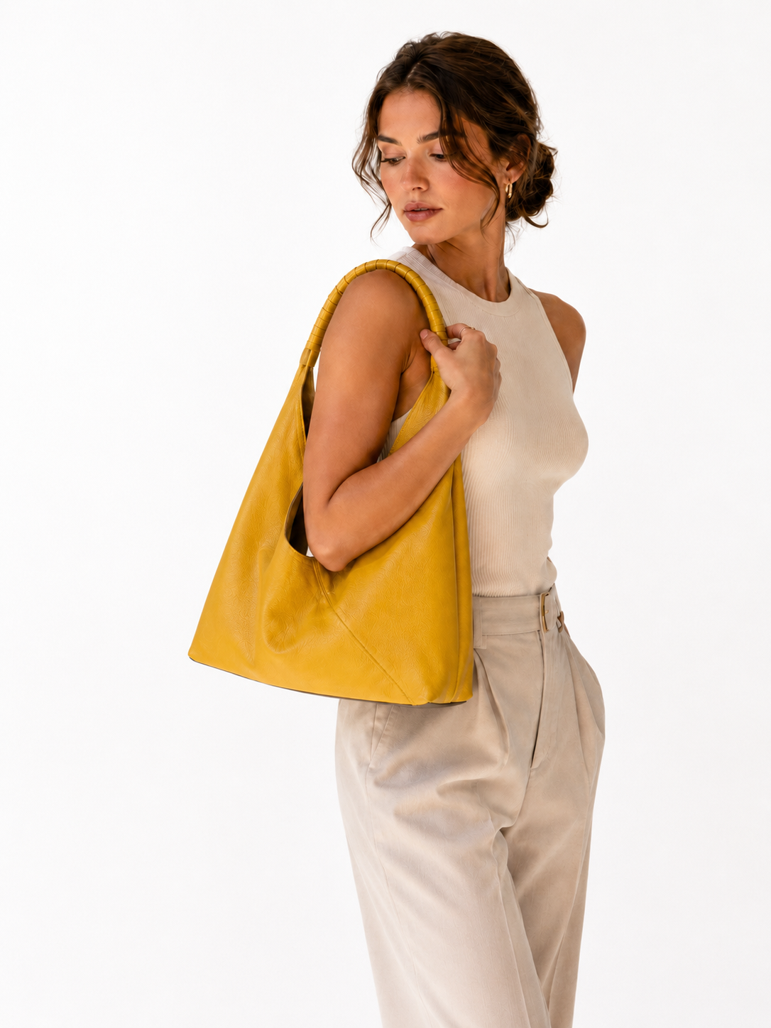 #Yellow top-grain leather hobo shoulder bag worn by woman in minimalist neutral setting