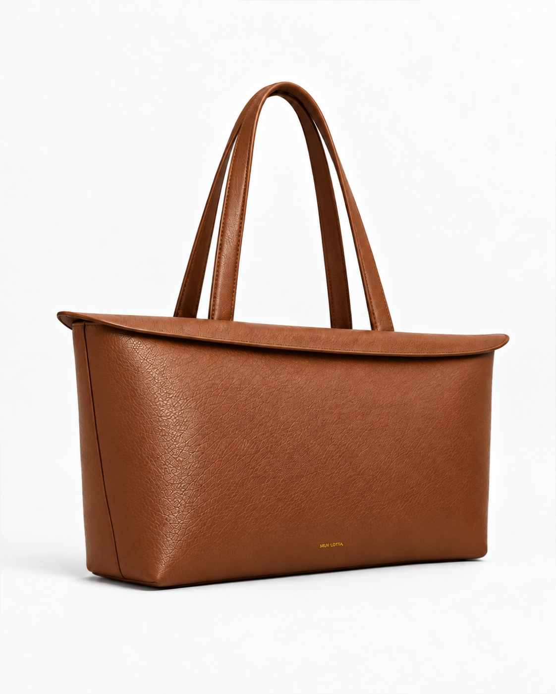 Three-quarter side view of the MUY LOTTA Floating Eave Span Cognac leather tote.