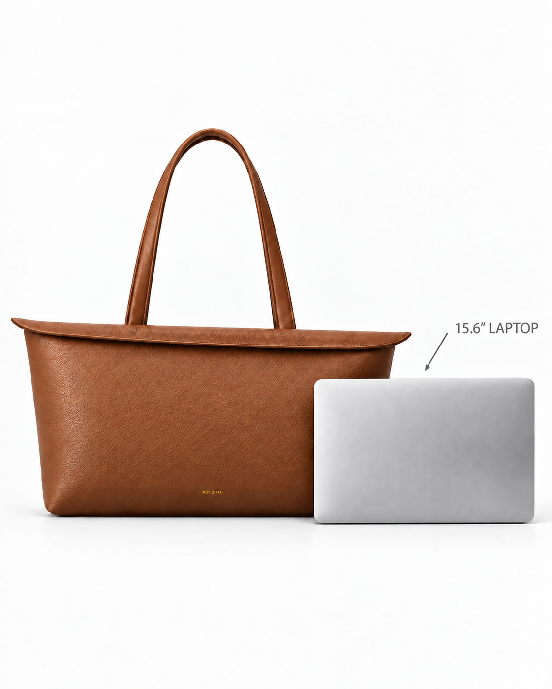 MUY LOTTA Floating Eave Span Cognac tote shown beside a 15.6-inch laptop for scale.