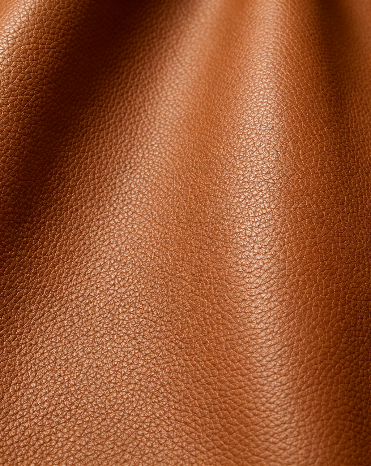 Close-up of the fine-grain Cognac surface of the MUY LOTTA Floating Eave Span tote.