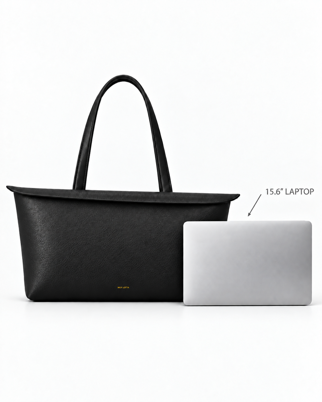 MUY LOTTA Floating Eave Span Soft Black tote shown beside a 15.6-inch laptop for scale.