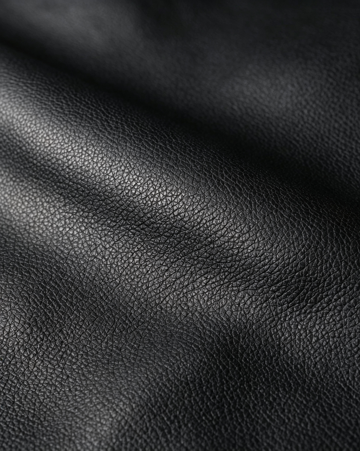 Close-up of the fine-grain Soft Black surface of the MUY LOTTA Floating Eave Span tote.