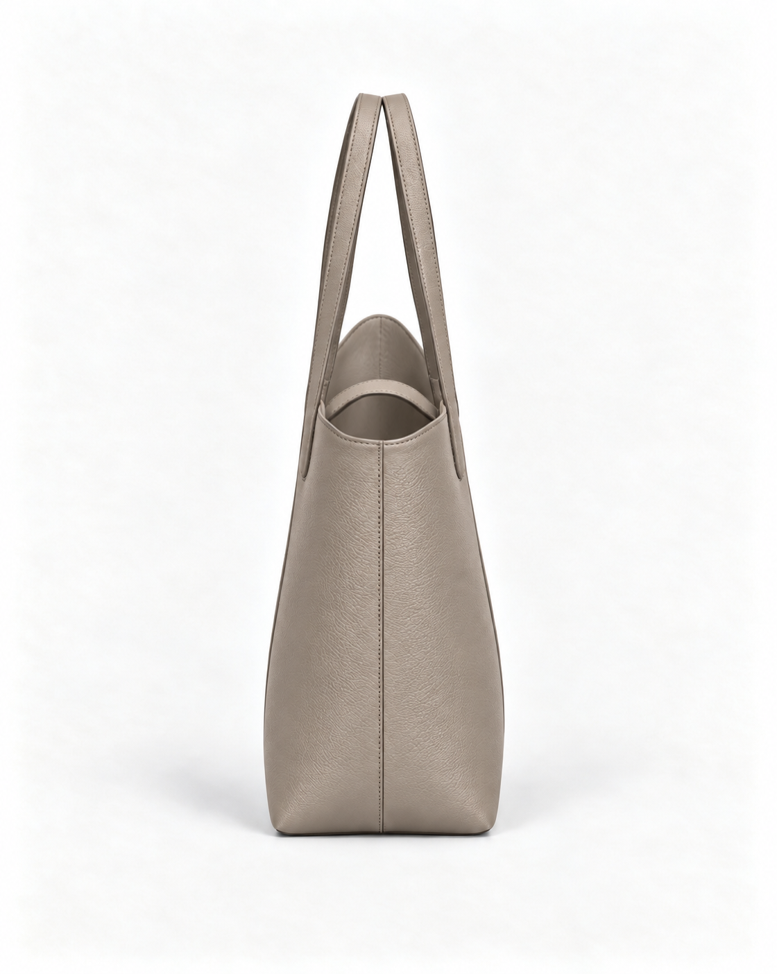 Side view of the MUY LOTTA VEER Axis Gray Taupe asymmetric leather tote.