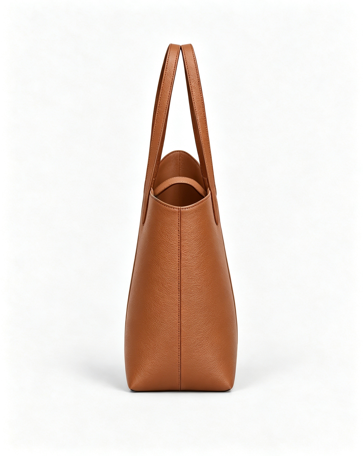 Side view of the MUY LOTTA VEER Axis Warm Brown asymmetric leather tote.