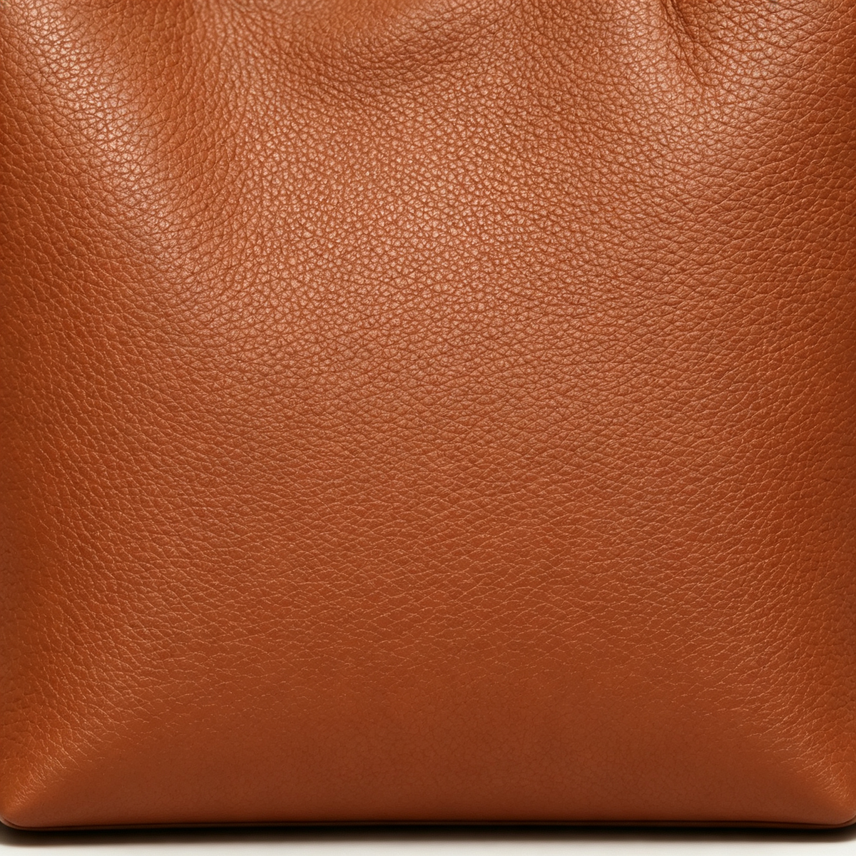 Close-up of the fine-grain Warm Brown surface of the MUY LOTTA VEER Axis tote.